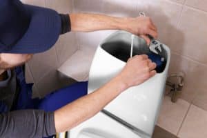 plumber fixing toilet problem