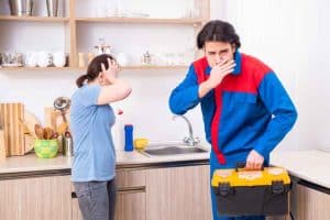 Homeowner consulting a plumber